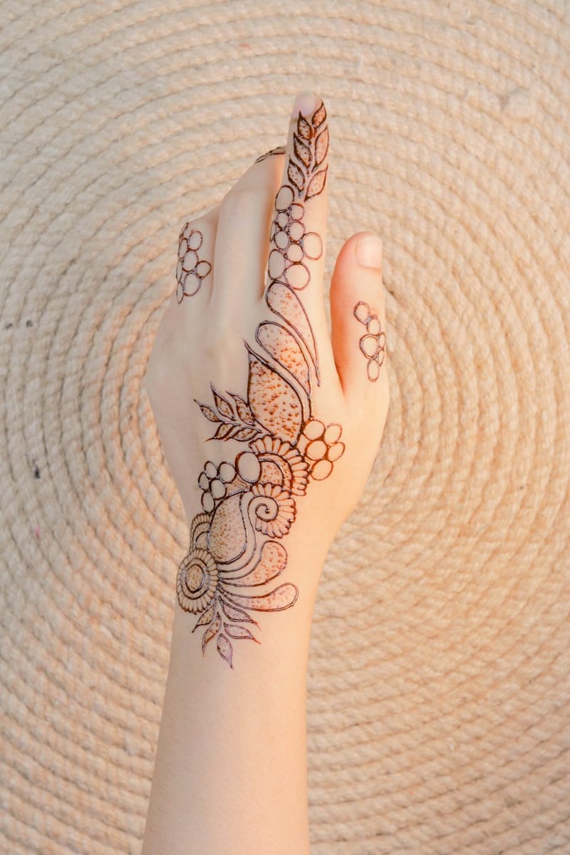 Arabic mehndi design with bold shaded petals and open negative spaces