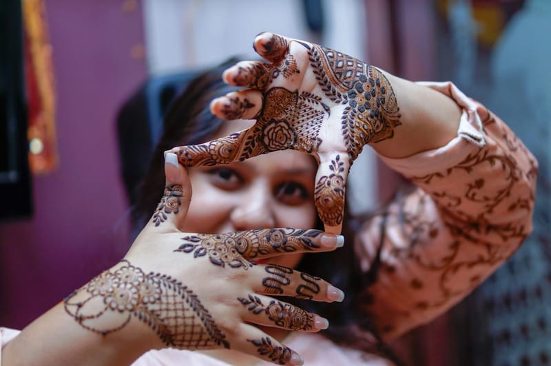 Understated botanical accent mehndi on side of hand for modern brides