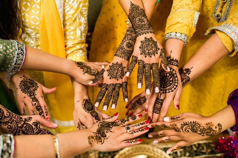 Festive circular mandala glow mehndi on backhand for bridesmaids